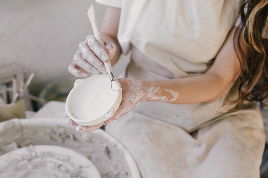 beautiful-woman-sculptor-creating-ceramics-using-wheel-in-a-private-pottery_t20_Joa9XP
